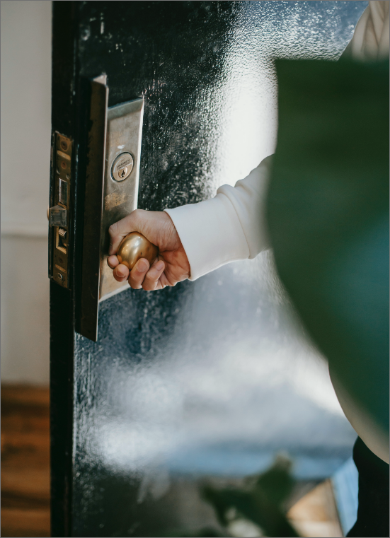 a hand opening a door